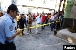 A police officer secures the scene of an explosion where a suspected suicide bomber targeted a wedding celebration in the Turkish city of Gaziantep, Turkey, Aug. 21, 2016.