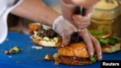 FILE - French burgers are prepared at 'Le Refectoire' food truck in Paris, Nov. 16, 2012. (REUTERS/Charles Platiau)