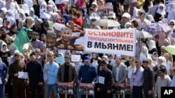RuChechens hold a banner reading "Stop genocide of Muslims in Myanmar" during a mass protest in Chechnya's provincial capital Grozny, Sept. 4, 2017. 