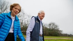FILE - In this Feb. 8, 2017, file photo former President Jimmy Carter, right, and his wife Rosalynn arrive for a ribbon cutting ceremony for a solar panel project on farmland he owns in their hometown of Plains, Georgia, USA.