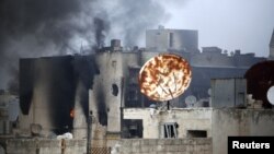 Smoke rises from a damaged building hit by pro-government forces as clashes continue with the Free Syrian Army, near the Old Town of Aleppo, November 2, 2012.