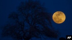 FILE - A super blue blood moon rises over Michmoret, Israel, Jan. 31, 2018. 