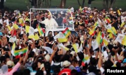 Pope Francis waves to Catholic faithful as he arrives to lead a mass at Kyite Ka San Football Stadium in Yangon, Nov. 29, 2017.