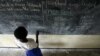 Grace Debroha, a 13-year-old orphan, writes the names of body parts on a chalkboard at St. Jude's Orphanage, outside Gulu, Uganda, June 10, 2007.