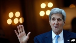 U.S. Secretary of State John Kerry talks to reporters as he leaves his hotel on the way to Mass at the St. Stephen's Cathedral in Vienna, Austria, July 12, 2015.