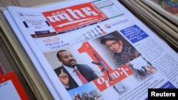 FILE - Ethiopia’s Prime Minister Abiy Ahmed and leader of the Tigray People's Liberation Front (TPLF) party Debretsion Gebremichael are pictured on a copy of a local newspaper, in Addis Ababa, Ethiopia, Nov. 3, 2021.