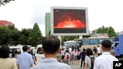 People watch a news broadcast of a missile launch in Pyongyang, North Korea, July 29, 2017. North Korean leader Kim Jong Un said Saturday the second flight test of an intercontinental ballistic missile demonstrated his country can hit the U.S. mainland.
