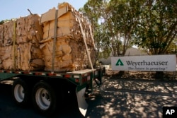 FILE - A truck loaded with recycled cardboard arrives at The Weyerhaeuser Co. Hueneme Paper Mill plant in Oxnard, California, March 17, 2008.