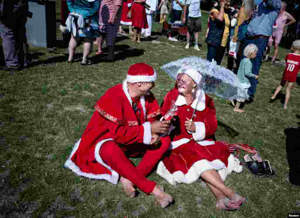 Participants gather at Bellevue Beach during the Santa Claus World Congress at Bakken, north of Copenhagen, Denmark, July 23, 2019. (Liselotte Sabroe/Ritzau Scanpix)