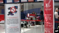 Signs list prohibited carry-on items at the entrance to a Casablanca-New York flight checkpoint at Casablanca Mohammed V International Airport, in Casablanca, Morocco, March 29, 2017.