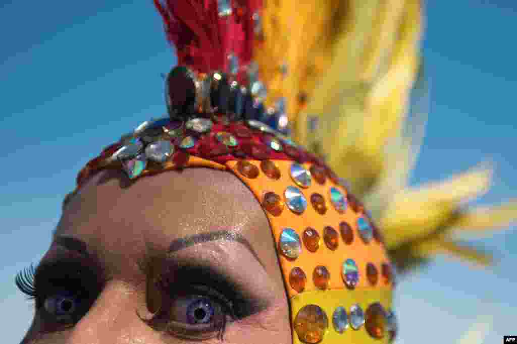 A man poses during the gay pride parade at Copacabana beach in Rio de Janeiro, Brazil, Oct. 13, 2013.