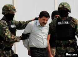 Joaquin Guzman (C) is escorted by soldiers in Mexico City Feb. 22, 2014.
