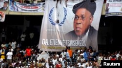 A banner dedicated to Etienne Tshisekedi, former Congolese opposition figure who died in Belgium two years ago, hangs above supporters during a mourning ceremony at the Martyrs of Pentecost Stadium in Kinshasa, Democratic Republic of Congo, May 31, 2019.
