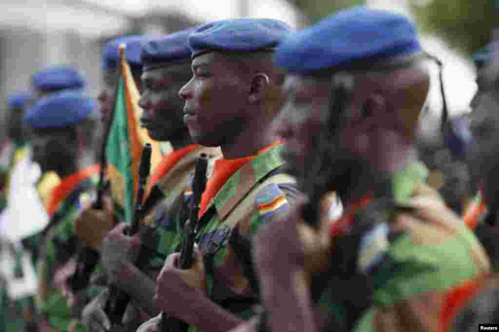 Ivory Coast soldiers stand at guard during a ceremony in Abidjan to honor soldiers killed in last month&#39;s al-Qaida attack on the beach resort town of Grand Bassam.