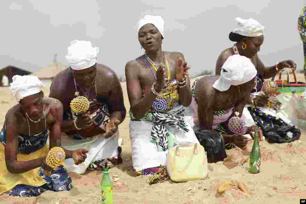 Voodoo worshipers make sacrifice at the beach during the annual Voodoo Festival in Ouidah, Benin.