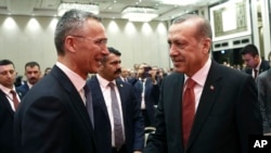 Turkey's President Recep Tayyip Erdogan, right, and NATO Secretary-General Jens Stoltenberg shake hands as they attend a NATO parliamentary assembly meeting in Istanbul, Nov. 21, 2016. 