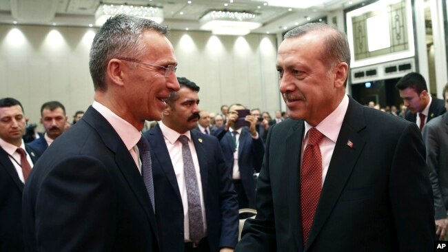 FILE - Turkey's President Recep Tayyip Erdogan, right, greets NATO Secretary-General Jens Stoltenberg at a NATO parliamentary assembly meeting in Istanbul, Nov. 21, 2016.