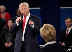 Republican presidential nominee Donald Trump points at Democratic presidential nominee Hillary Clinton as he speaks during the second presidential debate at Washington University in St. Louis, Oct. 9, 2016.