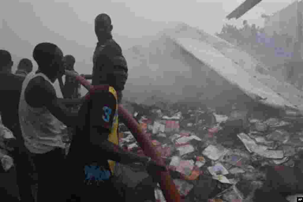 Rescue workers search for survivals at the site of a Dana Airlines passenger plane crash in Lagos, Nigeria, Sunday, June 3, 2012.