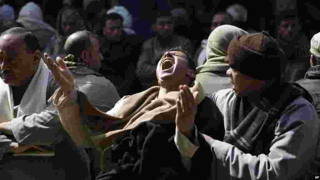 Jemaat Koptik Mesir berduka cita atas 21 pria Koptik Mesir yang dipenggal kepalanya oleh militan Negara Islam (ISIS) di Sirte, Libya, di Gereja Perawan Maria di desa el-Aour, dekat Minya, 220 kilometer dari selatan Kairo, Mesir (16/2).​&nbsp;(AP/Hassan Ammar)
