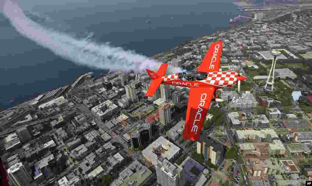 Team Oracle stunt pilot Sean D. Tucker flies his Extra 300L plane above the Space Needle in Seattle, Washington, Aug. 2, 2017.
