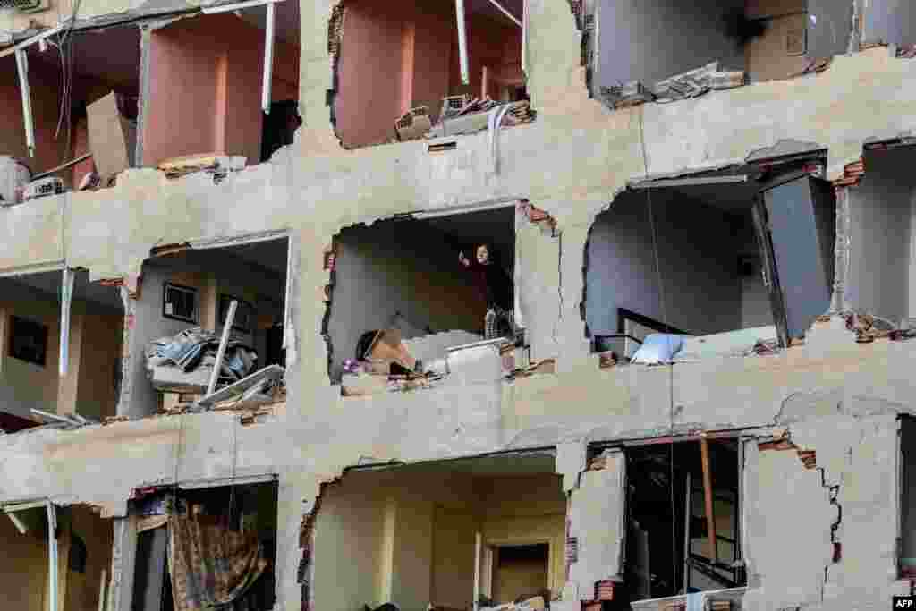 A woman reacts in her damaged apartment on the explosion site, after a strong blast in the southeastern Turkish city of Diyarbakir. At least one person was killed and 30 injured in a blast outside a police building.