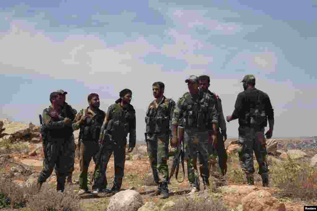 Forces loyal to President Bashar al-Assad advance towards Aleppo Central prison that has been sieged by rebels for over a year, north of Aleppo, May 21, 2014.