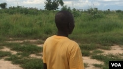 Boko Haram defector Bana Umar is seen at an undisclosed location. Umar agreed to be photographed on condition that his face not be shown. (H. Dauda for VOA Hausa). 