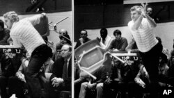 FILE - This Feb. 23, 1985, file photo shows Indiana coach Bob Knight winding up and pitching a chair across the floor during Indiana's 72-63 loss to Purdue, in Bloomington, Ind.