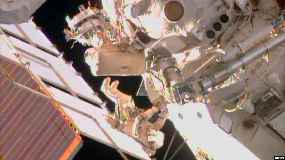 FILE - Two Russian cosmonauts are seen working outside the International Space Station during a spacewalk in this still image taken from NASA handout video, August 16, 2013.