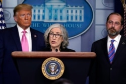 President Donald Trump, with members of the president's coronavirus task force, listens as Anne Schuchat, principal deputy director of the CDC at the White House, Feb. 26, 2020