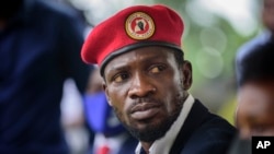 FILE - Opposition presidential challenger Bobi Wine, speaks to the media outside his home, in Magere, near Kampala, in Uganda, Jan. 26, 2021.