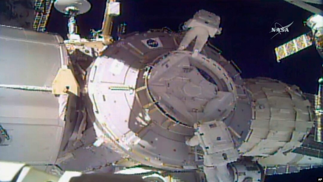 In this image made from video provided by NASA, U.S. astronauts Peggy Whitson, above, and Shane Kimbrough work on the outside of the International Space Station, March 30, 2017.