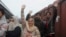Pakistani family waves to their Indian relatives, who are leaving to return to India, after being stranded in Pakistan for a week, at Lahore Railway Station in Pakistan, March 4, 2019. 