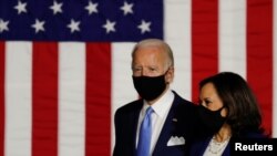 Democratic presidential candidate Joe Biden and vice presidential candidate Senator Kamala Harris take the stage at a campaign event, their first joint appearance, in Wilmington, Delaware, August 12, 2020. (REUTERS/Carlos Barria)