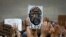 People hold up a likeness of George Floyd at a public memorial after his death in Minneapolis police custody, in the Brooklyn borough of New York City, New York, June 4, 2020.