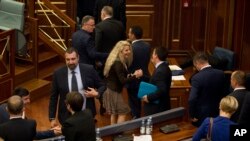 Kosovo lawmakers congratulate each other after the government lost a no-confidence motion during a parliamentary session in Pristina, Kosovo, on Wednesday, May 10, 2017.