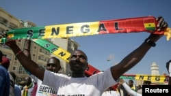 FILE —Senegalese protesters from civil society platform AAR SUNU Election hold a march to protest against the postponement of the presidential election that was scheduled for February 25 in Dakar, February 17, 2024