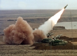 FILE - A "Buk" anti-aircraft battery launches a ground-to-air missile during the Ukrainian army's "Duel-99" military maneuvers at the Chauda firing ground in the Crimean peninsula, October 12, 2019.