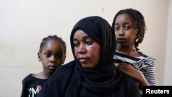 FILE: Sanaa Mahmoud, a Sudanese displaced woman, and her daughters Talia and Talien, who fled after the last crisis in Sudan's capital Khartoum, look on during an interview with Reuters as they stay at a shelter in the district of Boulaq Al-Dakrour in Giza, Egypt on May 13, 2023.