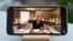 FILE - A photo taken May 26, 2021, in Istanbul, Turkey, shows a YouTube broadcast by exiled mob boss Sedat Peker on a mobile phone.