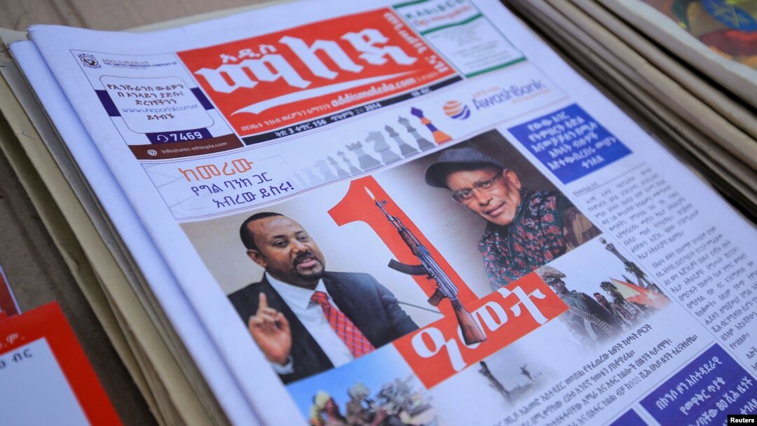 FILE - Ethiopia’s Prime Minister Abiy Ahmed and leader of the Tigray People's Liberation Front (TPLF) party Debretsion Gebremichael are pictured on a copy of a local newspaper, in Addis Ababa, Ethiopia, Nov. 3, 2021.