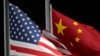 FILE - The American and Chinese flags wave at Genting Snow Park ahead of the 2022 Winter Olympics, in Zhangjiakou, China, on Feb. 2, 2022.