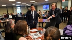 FILE - Department of Homeland Security (DHS) Acting Secretary Chad Wolf (L) and Cybersecurity and Infrastructure Security Agency (CISA) Director Christopher Krebs speak with election security experts in Arlington, Virginia, March 3, 2020.
