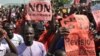 FILE - Protestors carry a sign reading "No to the referendum" and "No to Constitutional revision" during a demonstration against a referendum on a constitutional revision on July 1, 2017, in Bamako. 