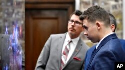 Kyle Rittenhouse, front, his attorney, Mark Richards, middle, and Assistant District Attorney Thomas Binger watch an aerial video of the moments where he shot Jospeh Rosenbaum on Aug. 25, 2020, during his trial at the Kenosha County Courthouse in Kenosha, Wis., Nov. 10, 2021.