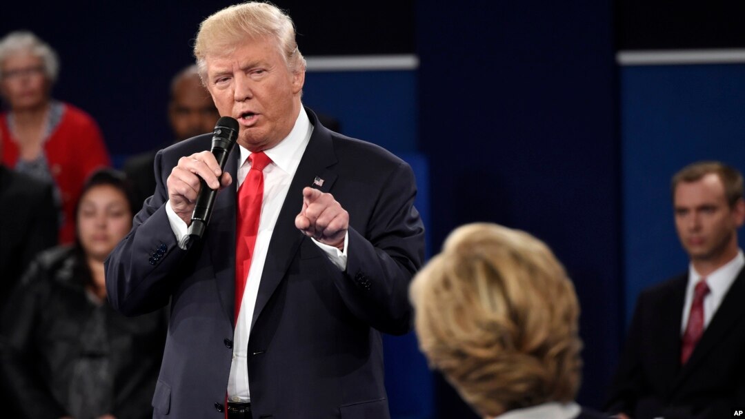 Republican presidential nominee Donald Trump points at Democratic presidential nominee Hillary Clinton as he speaks during the second presidential debate at Washington University in St. Louis, Oct. 9, 2016.