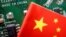 (FILE) A Chinese flag is displayed next to a "Made in China" sign seen on a printed circuit board with semiconductor chips on February 17, 2023. 