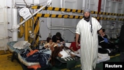 Injured men rest inside a Turkish ship carrying 250 wounded people from the besieged Libyan city of Misrata, at a port in Benghazi, Apr 3 2011.