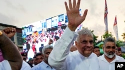 FILE - Sri Lankan President Ranil Wickremesinghe waves to supporters as he arrives to address a public election rally in Minuwangoda, Sri Lanka, Sept. 17, 2024.